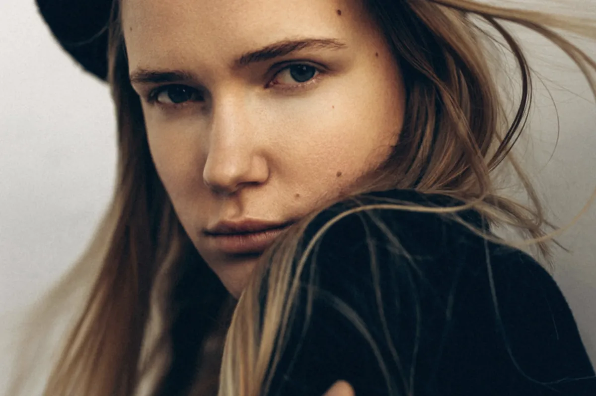 Close-up headshot for a model portfolio: natural make-up, soft window light